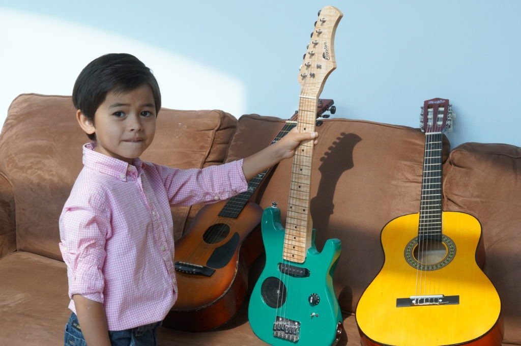 kid picking electric guitar 