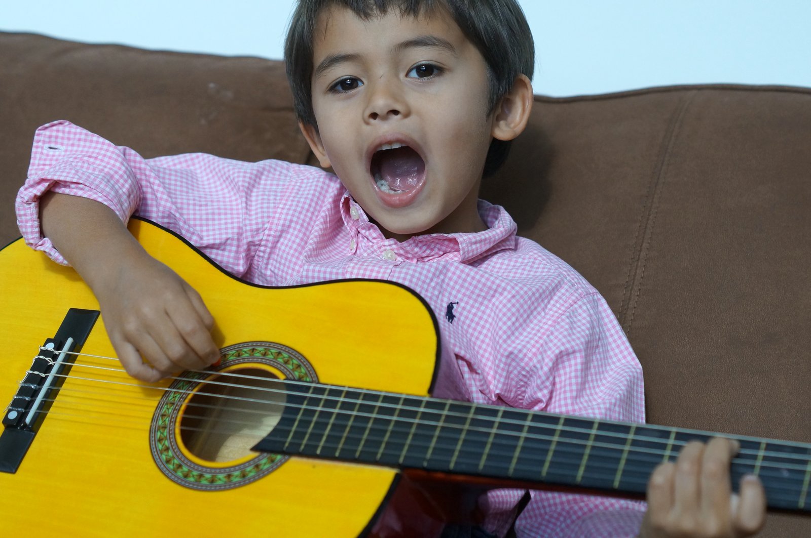 Kid Singing Playing Classical Guitar Children In Homes Music Lessons   Kid Singing Playing Classical Guitar 