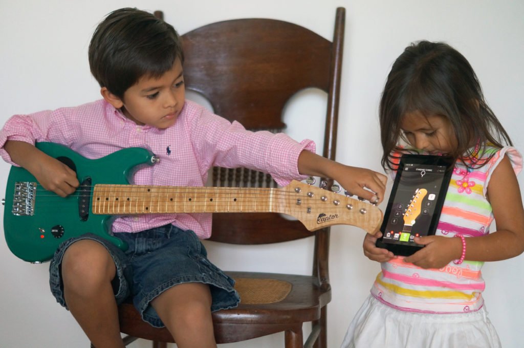 kids tuning electric guitar